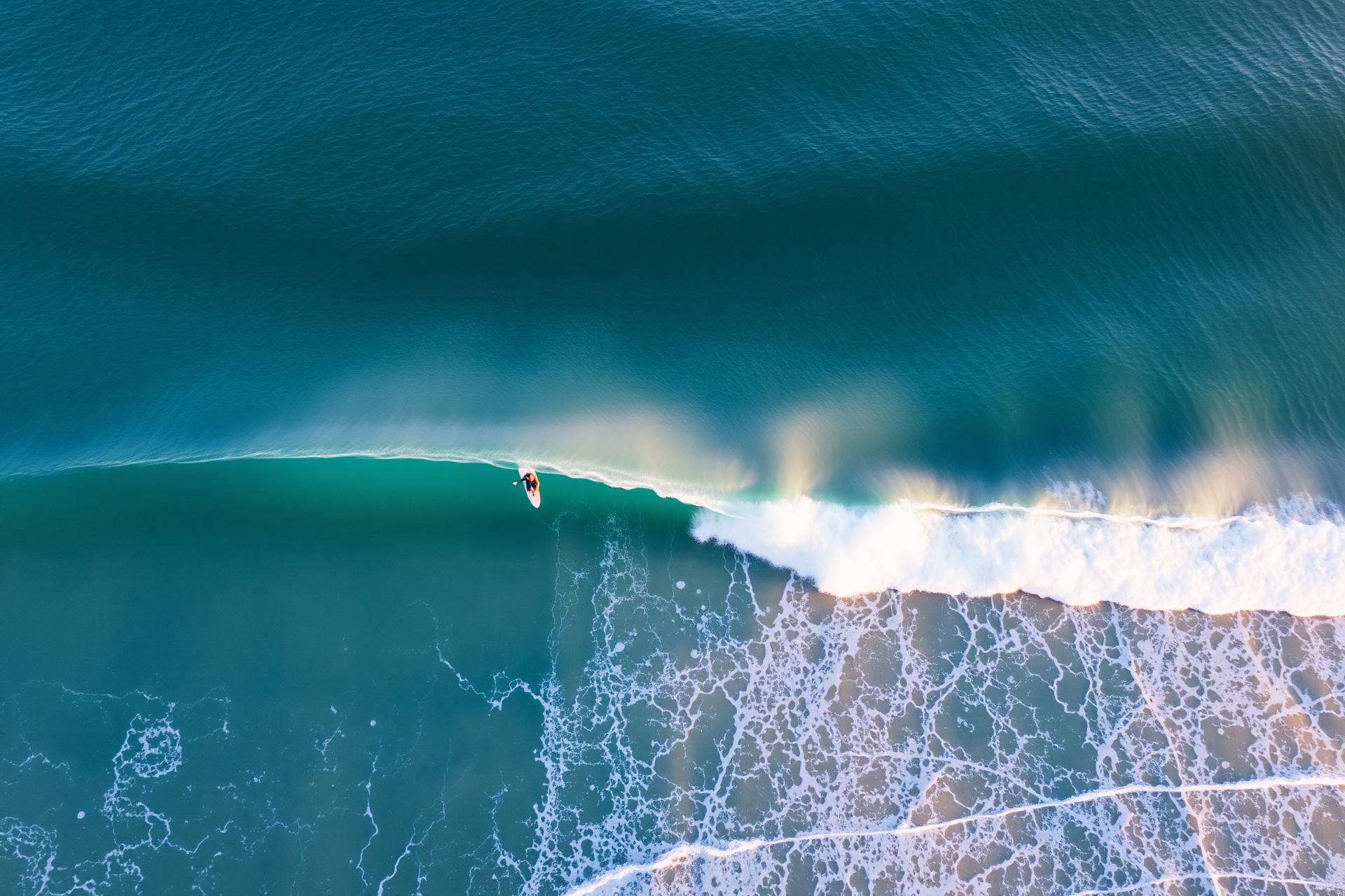 Aerial view of a glassy wave breaking at Carcavelos beach
